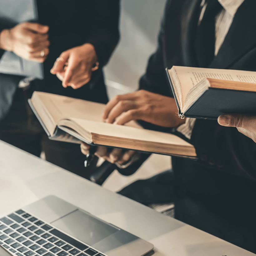 group of lawyers referring to texts at work group of lawyers referring to texts at work