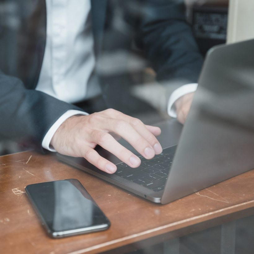 businessman-s-hand-typing-laptop-desk businessman-s-hand-typing-laptop-desk