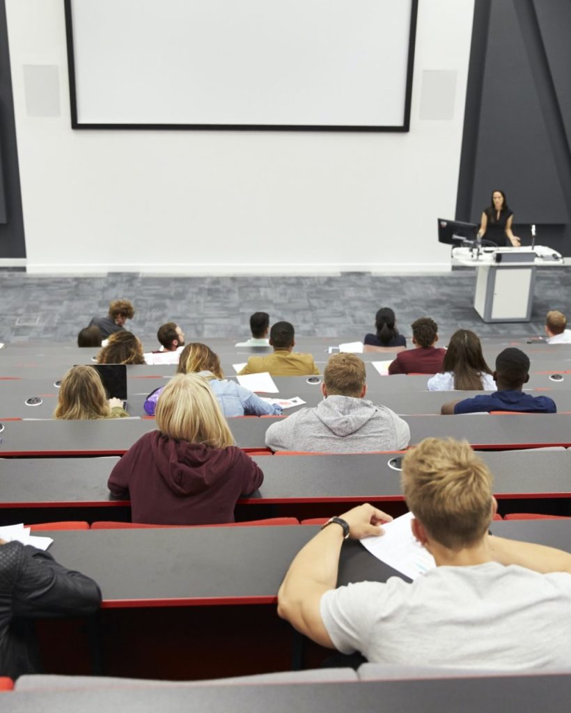 Lecture at university lecture theatre, audience POV